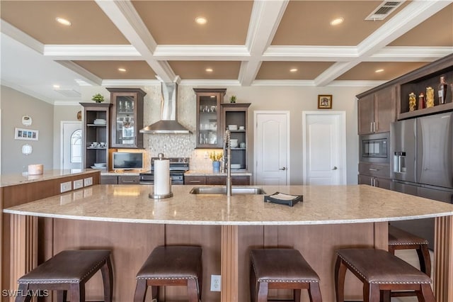 kitchen with a large island, a kitchen breakfast bar, light stone counters, and stainless steel appliances