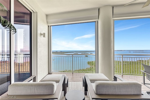 sunroom / solarium featuring a water view