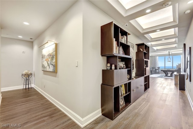 hall featuring a wall of windows and hardwood / wood-style flooring