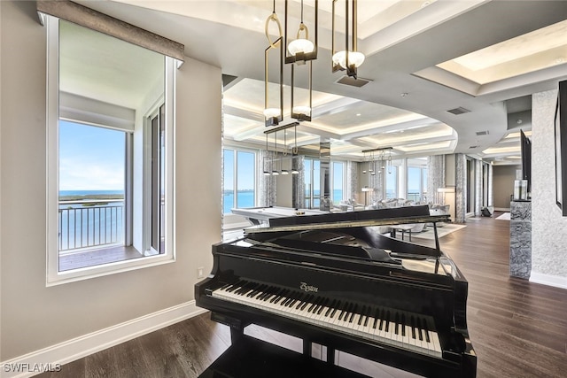 miscellaneous room with dark hardwood / wood-style flooring, beam ceiling, a water view, and coffered ceiling