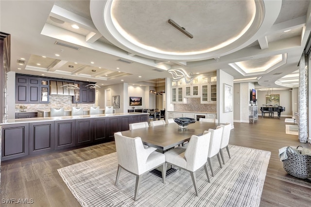 dining room featuring hardwood / wood-style flooring and a tray ceiling