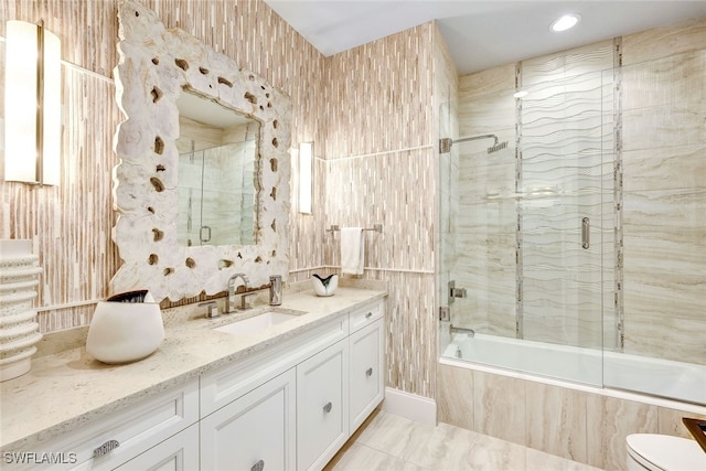 full bathroom with toilet, vanity, and combined bath / shower with glass door