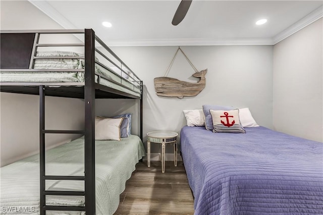 bedroom with crown molding, dark wood-type flooring, and ceiling fan