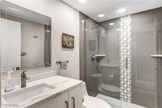 bathroom with vanity, toilet, and walk in shower