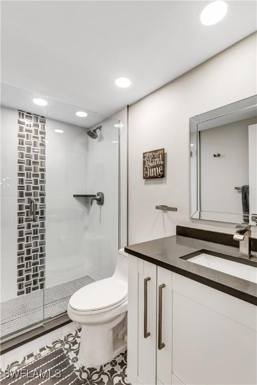 bathroom with walk in shower, vanity, and toilet