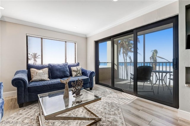 living room with crown molding and a water view