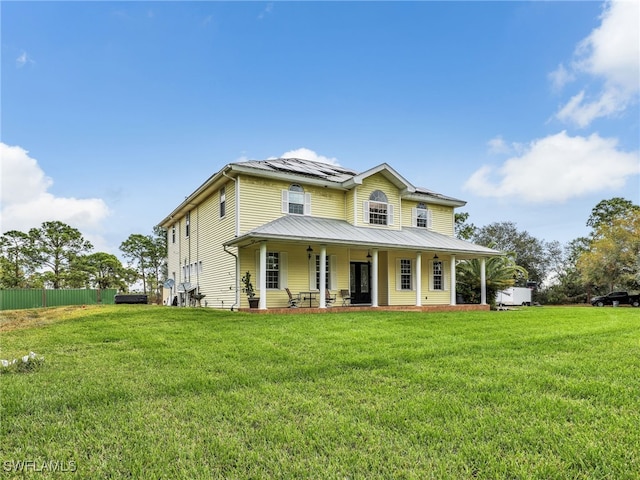 view of front of house featuring a front yard and solar panels