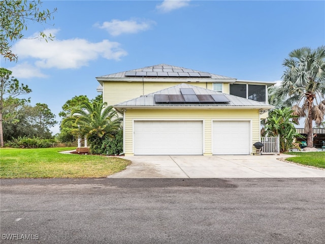 view of front of home with a front yard, solar panels, and a sunroom