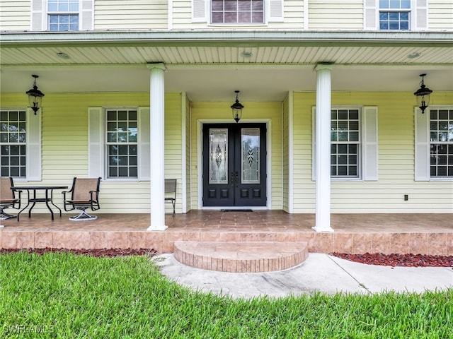 doorway to property featuring french doors and covered porch