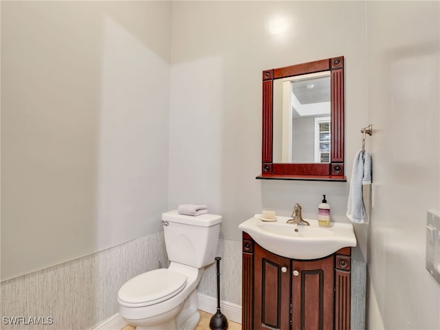 bathroom with tile patterned floors, vanity, and toilet