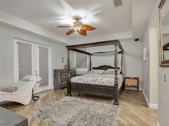 bedroom with french doors, light hardwood / wood-style flooring, and ceiling fan