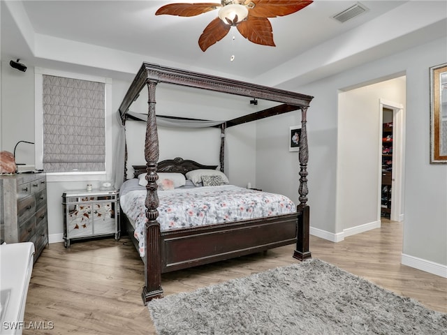 bedroom with ceiling fan and light hardwood / wood-style flooring