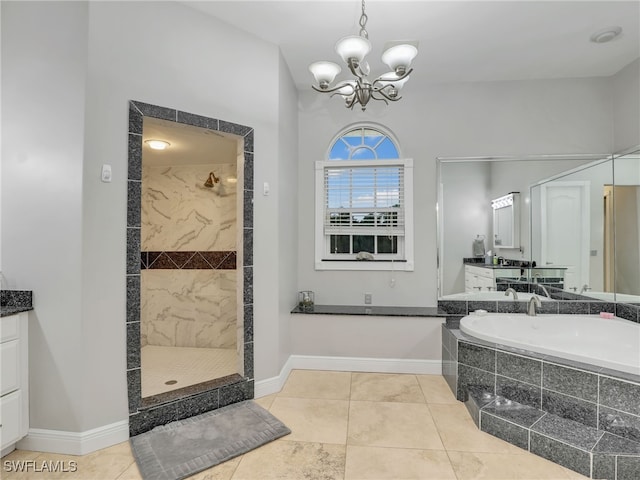 bathroom featuring tile patterned floors, plus walk in shower, vanity, and a notable chandelier