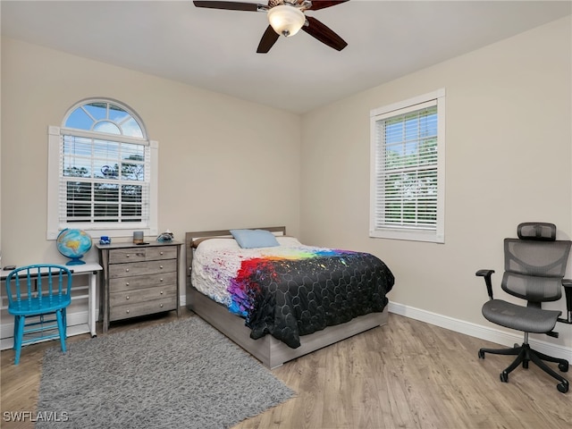 bedroom with ceiling fan and hardwood / wood-style flooring