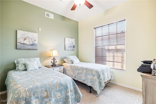 carpeted bedroom with baseboards, visible vents, and a ceiling fan