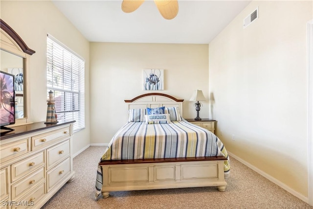 bedroom featuring light carpet, baseboards, visible vents, and ceiling fan