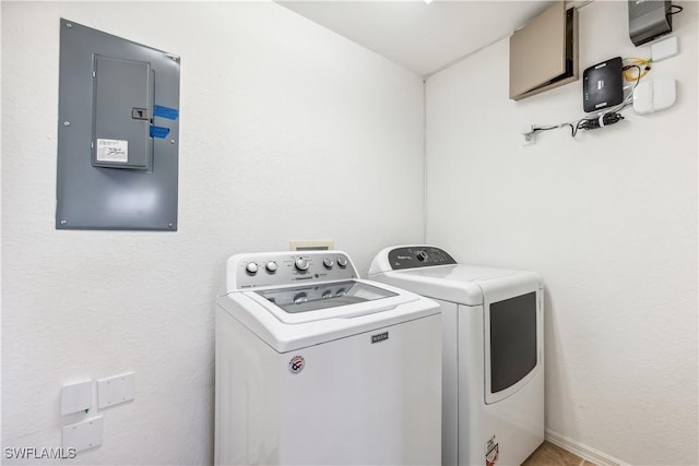 clothes washing area featuring laundry area, separate washer and dryer, and electric panel