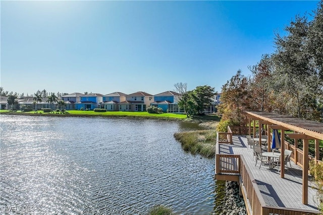 view of dock with a water view and a residential view