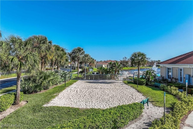 view of property's community featuring a residential view, a lawn, and volleyball court