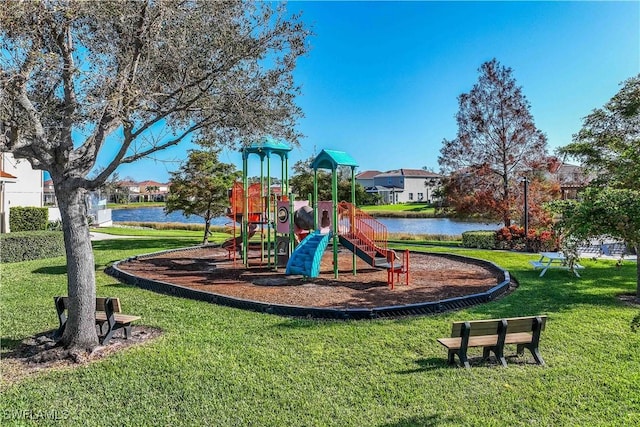 view of jungle gym featuring a lawn and a water view