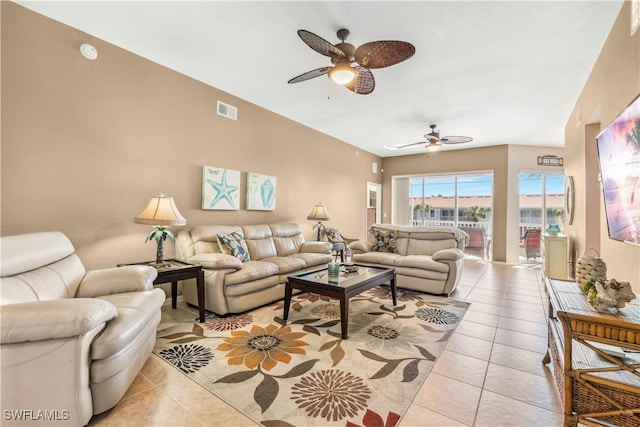 living room with light tile patterned flooring, visible vents, and a ceiling fan