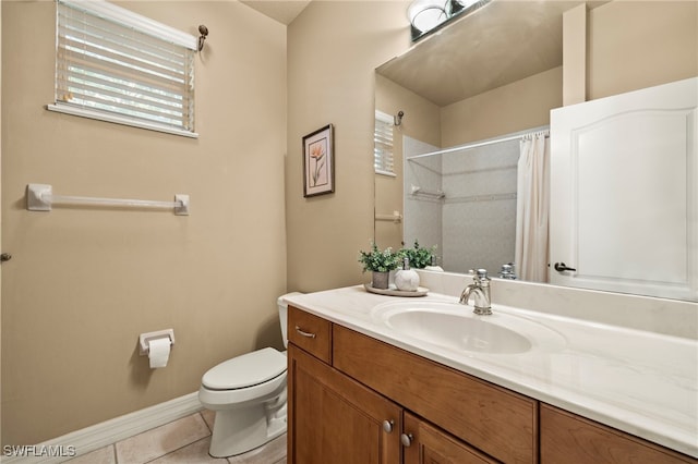 bathroom with toilet, vanity, tile patterned floors, and walk in shower