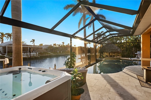 view of pool featuring a water view, a hot tub, a lanai, and a patio area