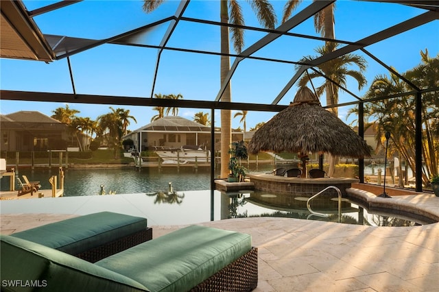 view of patio with glass enclosure, a water view, and a boat dock