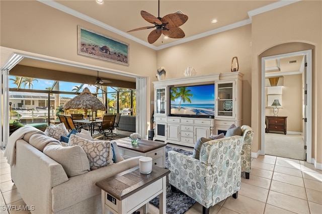 living room with crown molding, light tile patterned floors, and ceiling fan