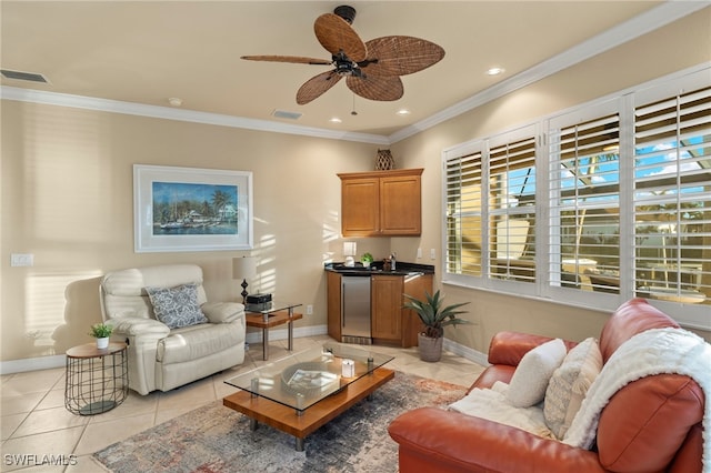 tiled living room with ceiling fan and crown molding