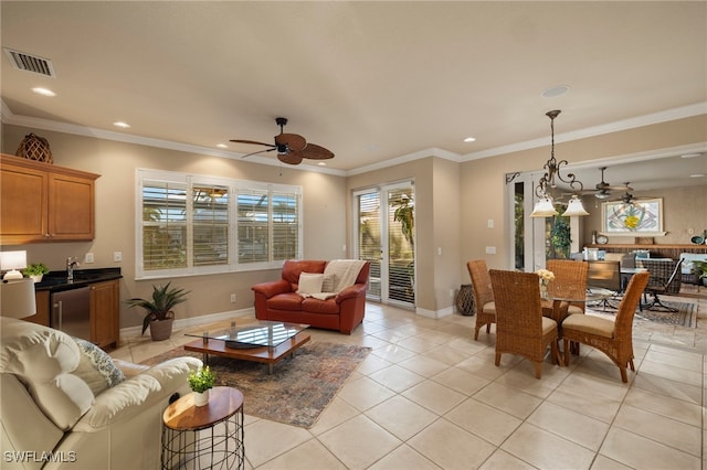 tiled living room with ceiling fan and crown molding