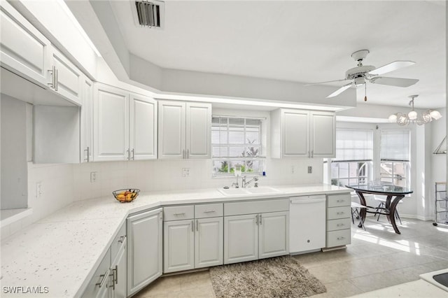 kitchen featuring dishwasher, ceiling fan with notable chandelier, white cabinetry, and sink