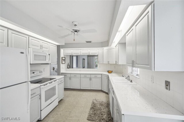 kitchen featuring white cabinetry, sink, ceiling fan, and white appliances