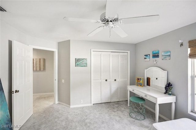 bedroom featuring ceiling fan, a closet, and light colored carpet