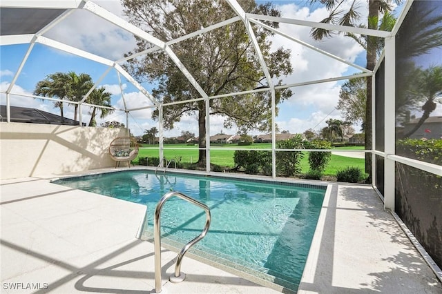 view of pool with glass enclosure and a patio