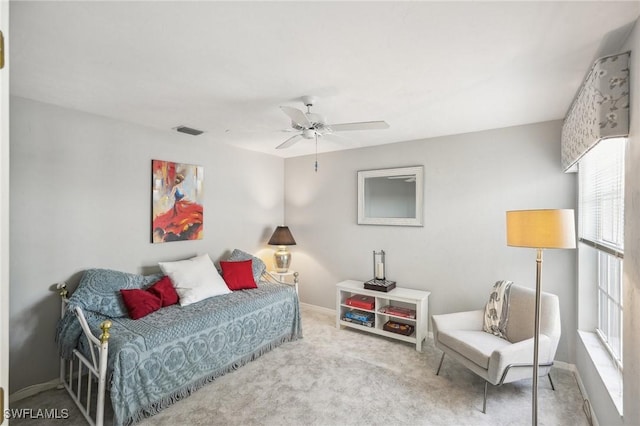 carpeted bedroom with ceiling fan and multiple windows