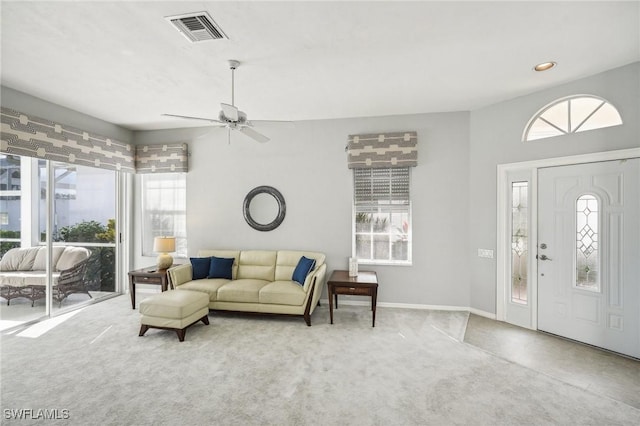 living room featuring carpet, ceiling fan, and a wealth of natural light