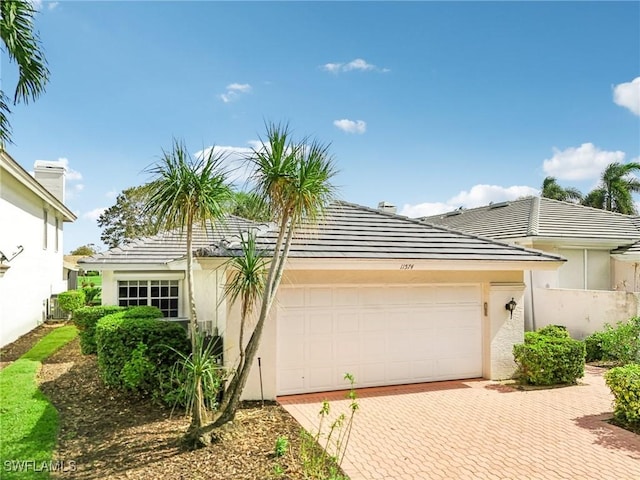 view of front of home with a garage and cooling unit