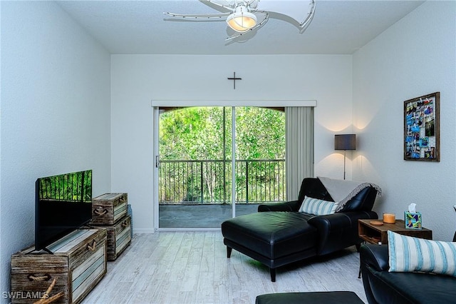 living room with ceiling fan and light hardwood / wood-style flooring