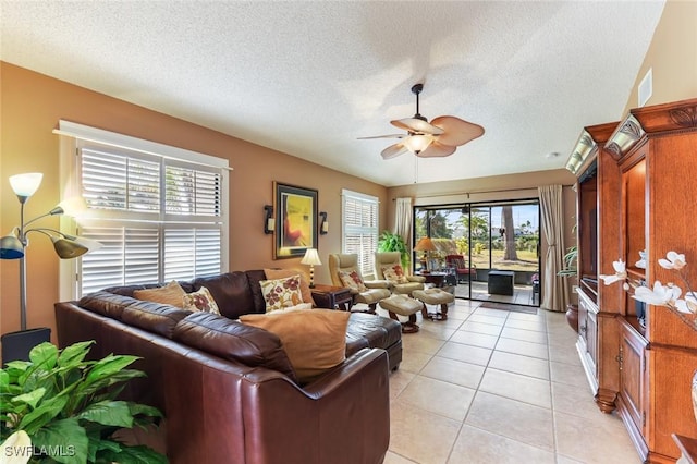 tiled living room featuring a textured ceiling, ceiling fan, and lofted ceiling