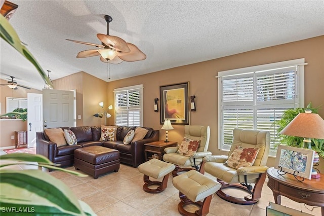 tiled living room featuring ceiling fan, a textured ceiling, and vaulted ceiling