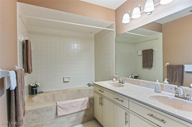 bathroom with vanity and tiled shower / bath