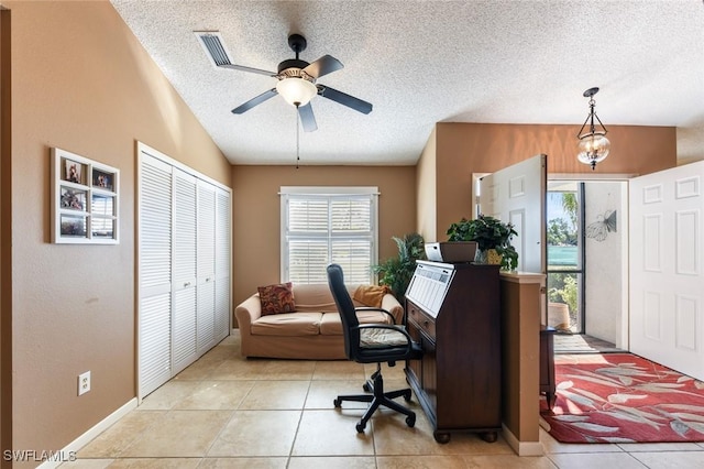 tiled home office featuring a textured ceiling, vaulted ceiling, and ceiling fan