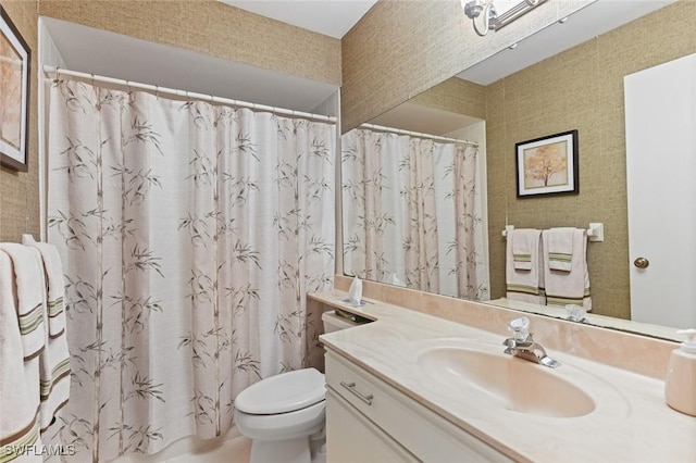 bathroom featuring vanity, curtained shower, and toilet