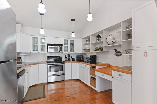 kitchen featuring lofted ceiling, appliances with stainless steel finishes, decorative light fixtures, light hardwood / wood-style floors, and white cabinetry