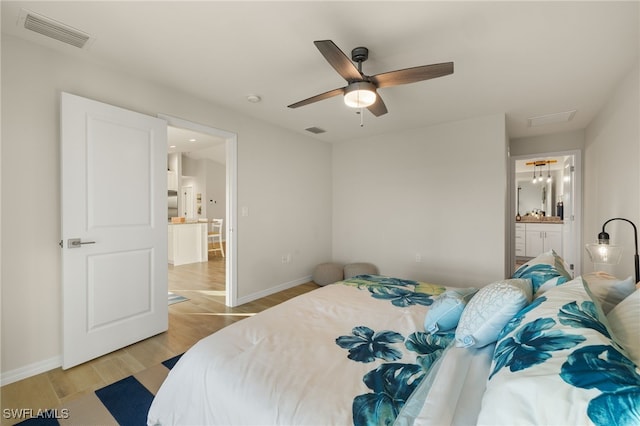 bedroom featuring light wood-type flooring, connected bathroom, and ceiling fan