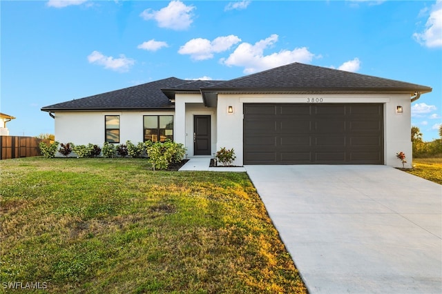 view of front of house featuring a front yard and a garage