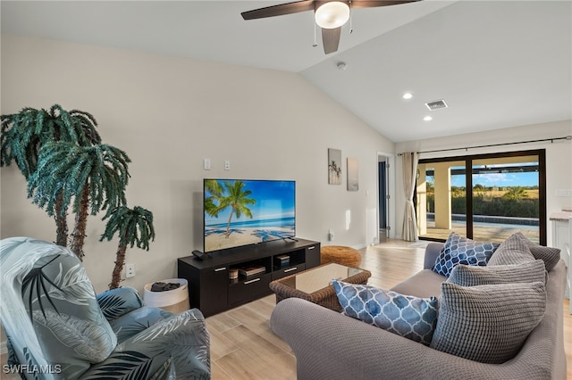 living room with ceiling fan, vaulted ceiling, and light hardwood / wood-style flooring