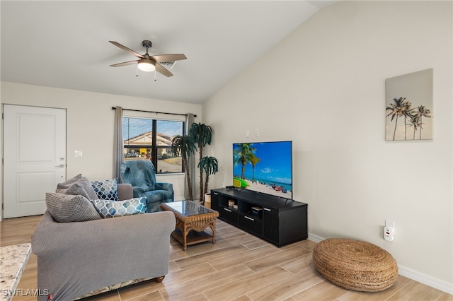 living room with ceiling fan, light wood-type flooring, and lofted ceiling