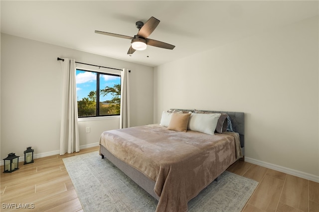 bedroom with light hardwood / wood-style floors and ceiling fan